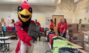 Cardinals and State Farm gift 567 backpacks to Laird School in Tempe