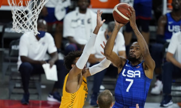 United States' Kevin Durant shoots over Australia's Matisse Thybulle during an exhibition basketbal...