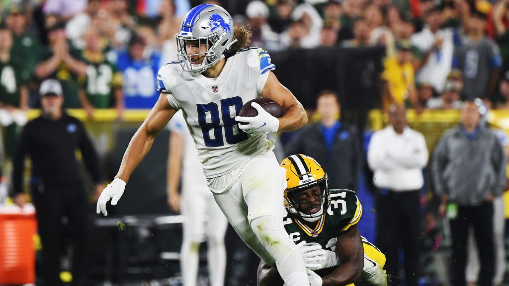 T.J. Hockenson #88 of the Detroit Lions runs against Adrian Amos #31 of the Green Bay Packers durin...