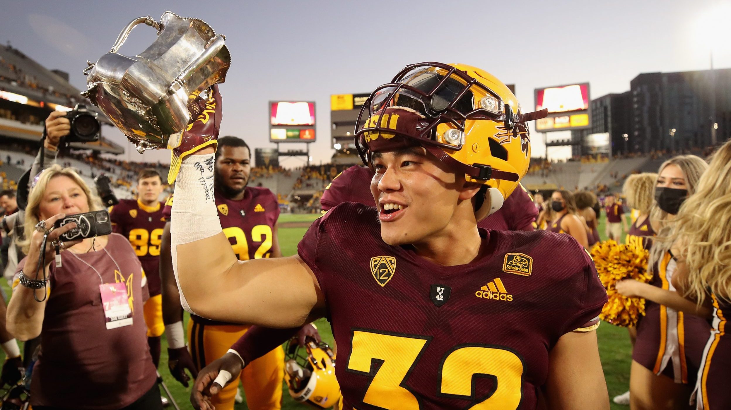 Running back Jackson He #32 of the Arizona State Sun Devils celebrates with the Territorial Cup aft...