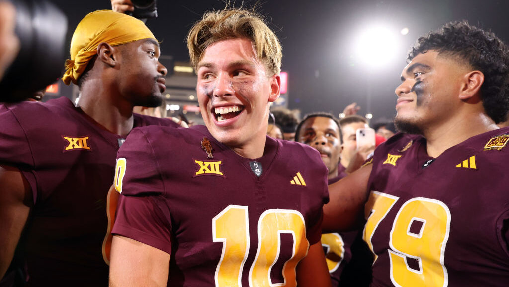Sam Leavitt #10 of the Arizona State Sun Devils celebrates with offensive lineman Leif Fautanu #79 ...