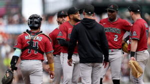 How far back are the Diamondbacks from a postseason spot with 15 games left?