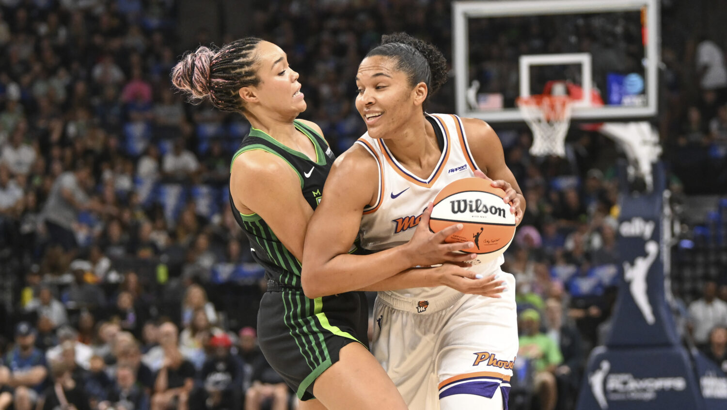 Phoenix Mercury forward Alyssa Thomas, right, tries to drive past Minnesota Lynx forward Napheesa C...
