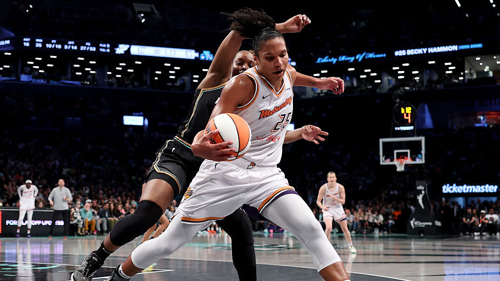 Alyssa Thomas #25 of the Phoenix Mercury controls the ball as Kennedy Burke #22 of the New York Lib...
