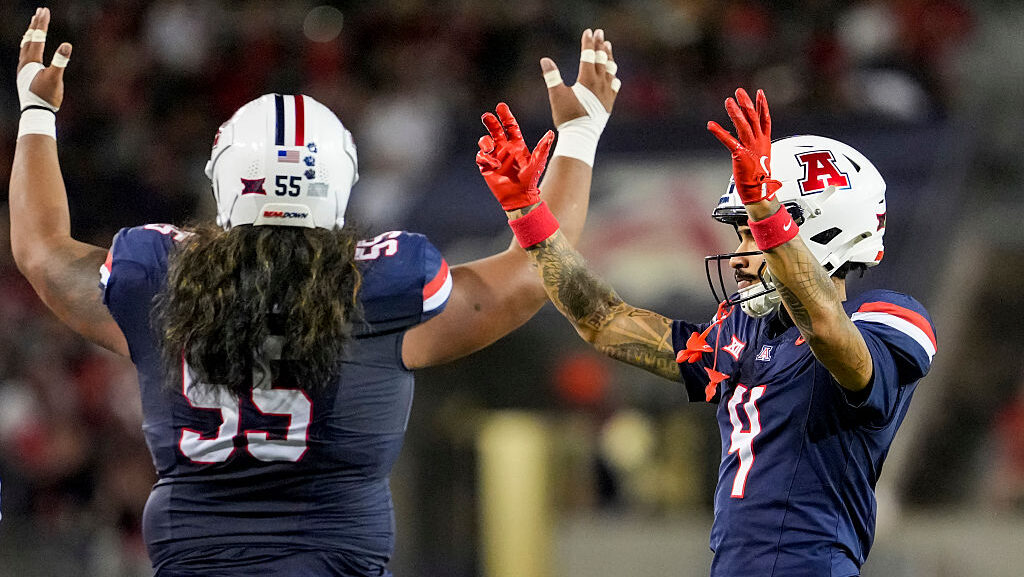 Wide receiver Kris Hutson #4 and teammate offensive lineman Chubba Maae #55 of the Arizona Wildcats...