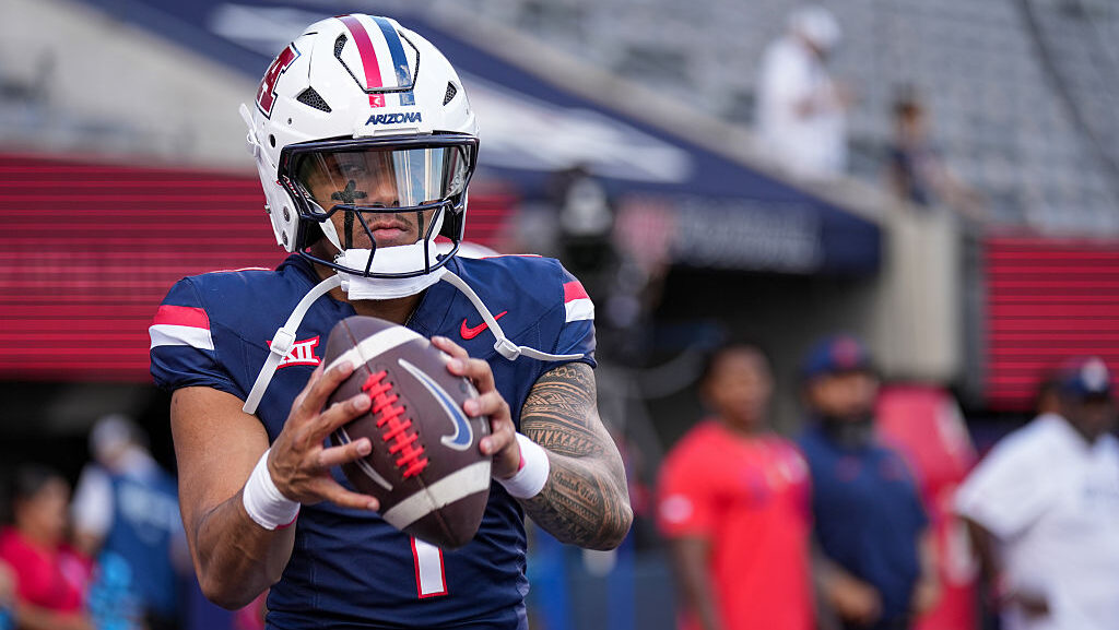 Quarterback Noah Fifita #1 of the Arizona Wildcats throws warm-up passes before the game against th...