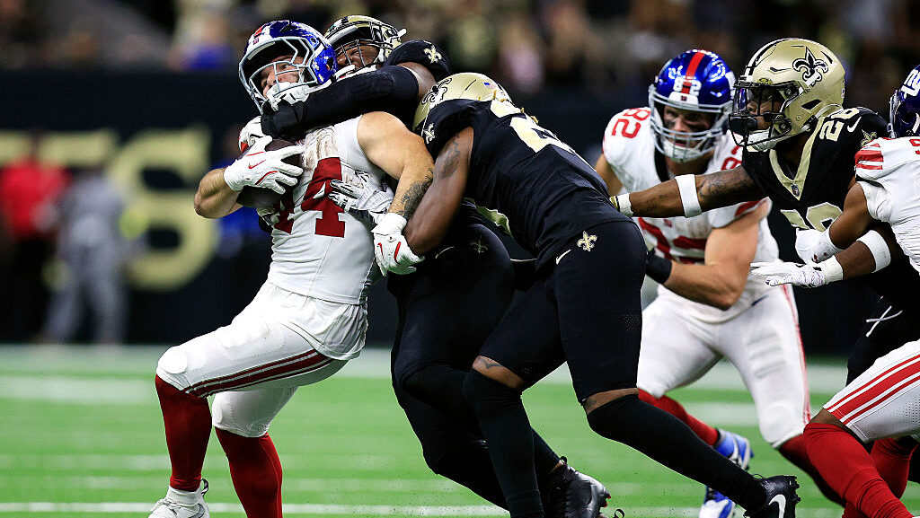 Cam Skattebo #44 of the New York Giants is tackled by Chris Rumph II #58 of the New Orleans Saints ...