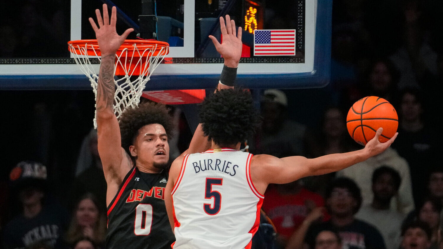 Arizona Wildcats guard Brayden Burries (5) attempts to shoot over Denver Pioneers forward Jeremiah ...