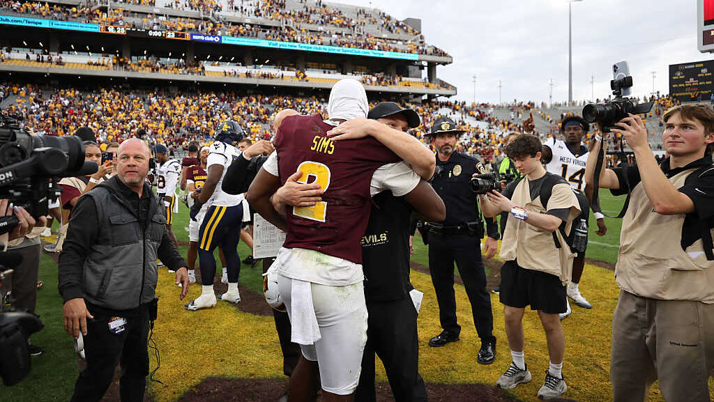 Head coach Kenny Dillingham of the Arizona State Sun Devils embraces quarterback Jeff Sims #2 of th...