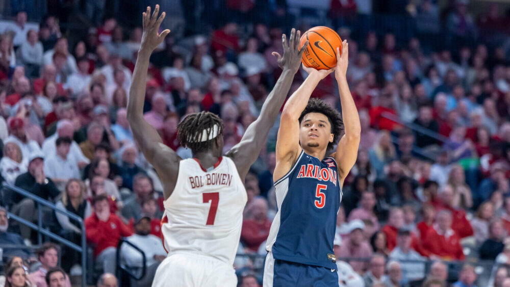 Alabama forward Amari Allen (5) shoots and hits a three-point shot over the defense of Alabama forw...