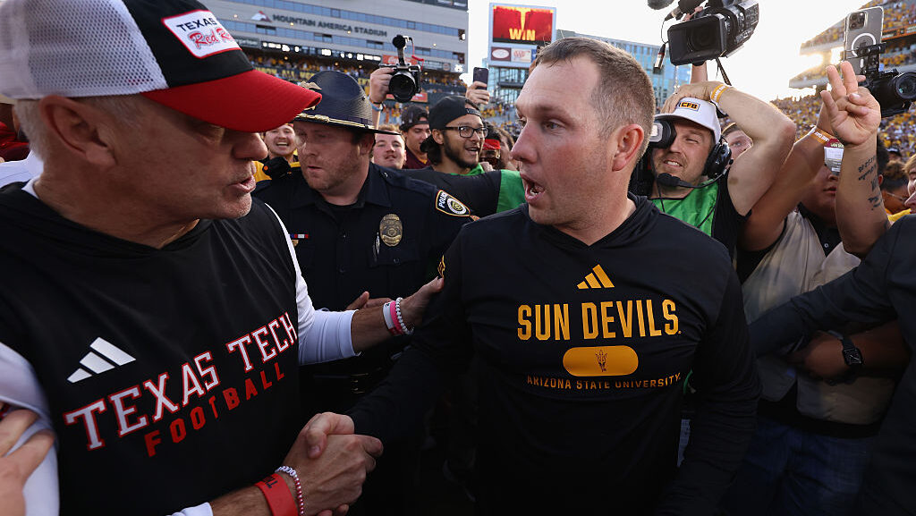 Head coaches Kenny Dillingham (R) of the Arizona State Sun Devils...