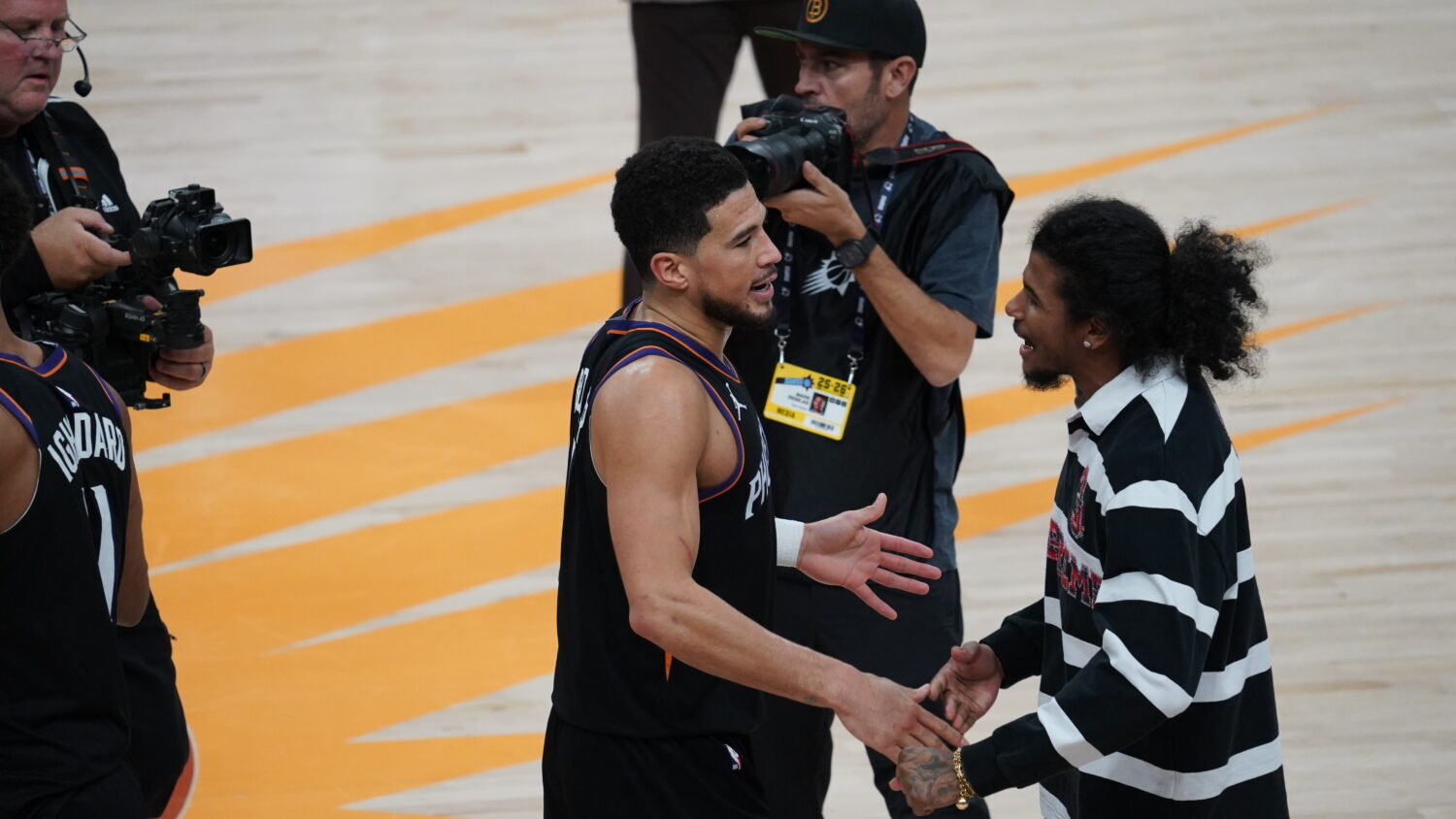 Suns guard Devin Booker greets teammate Jalen Green after a Jan. 4, 2026, win over the Oklahoma Cit...