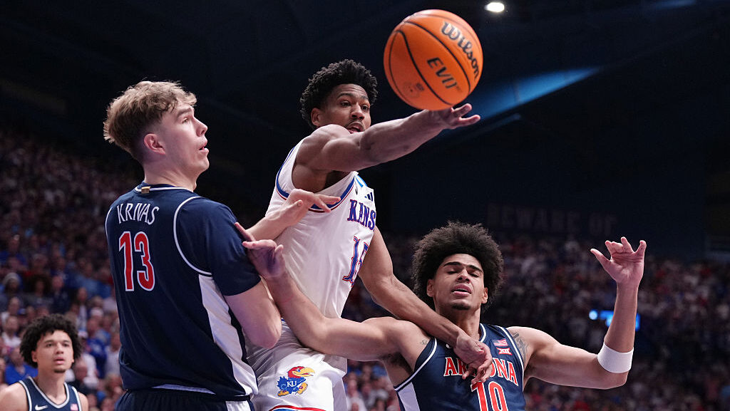 Forward Bryson Tiller #15 of the Kansas Jayhawks loses control of the ball against center Motiejus ...