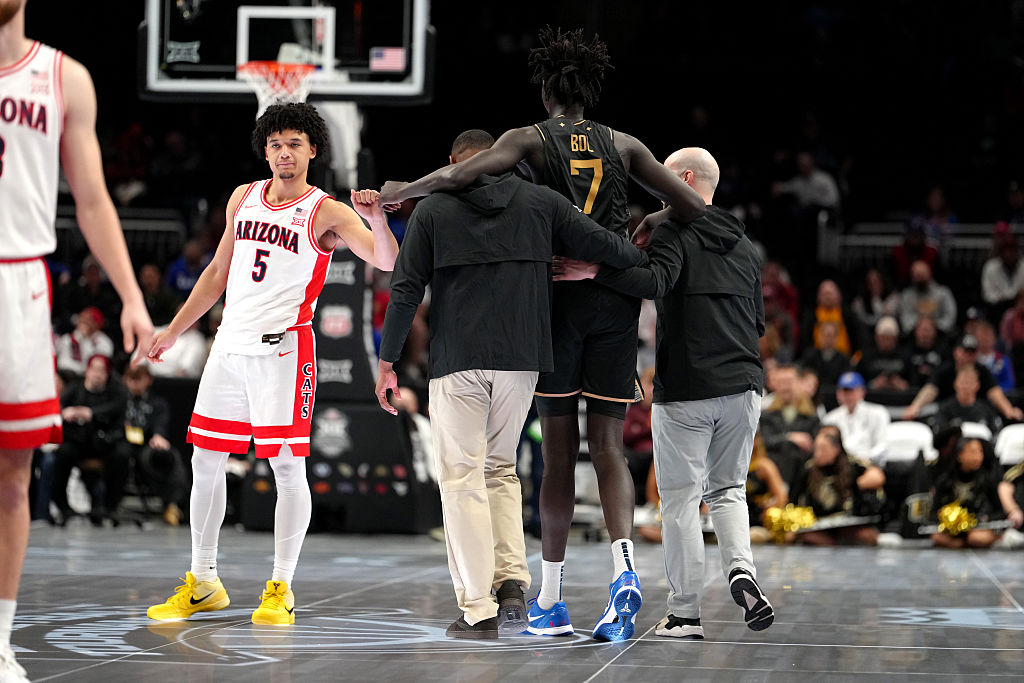 KANSAS CITY, MISSOURI - MARCH 12: John Bol #7 of the UCF Knights receives a fist bump from Brayden ...