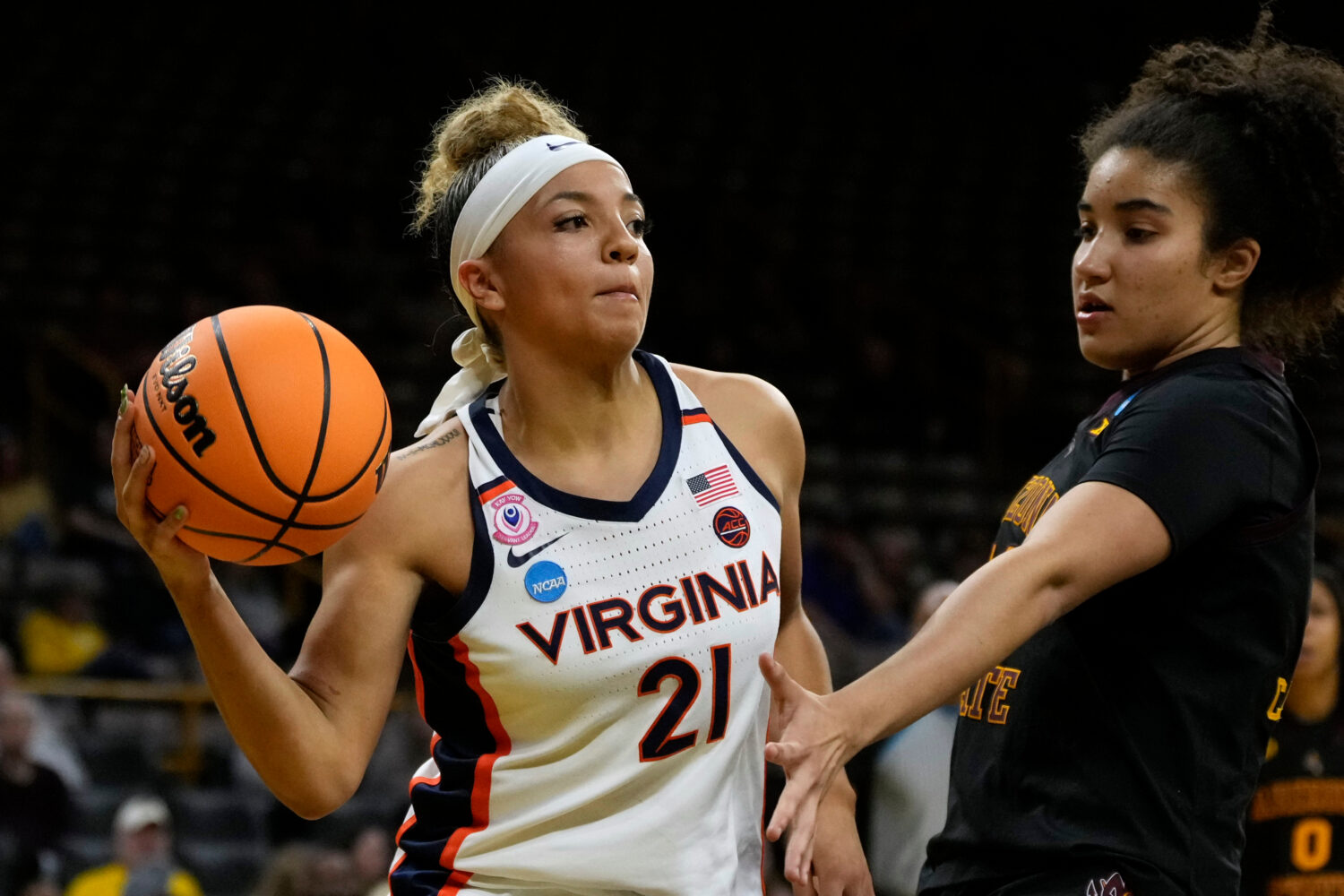 Virginia guard Kymora Johnson (21) passes around Arizona State forward Heloisa Carrera, right, duri...