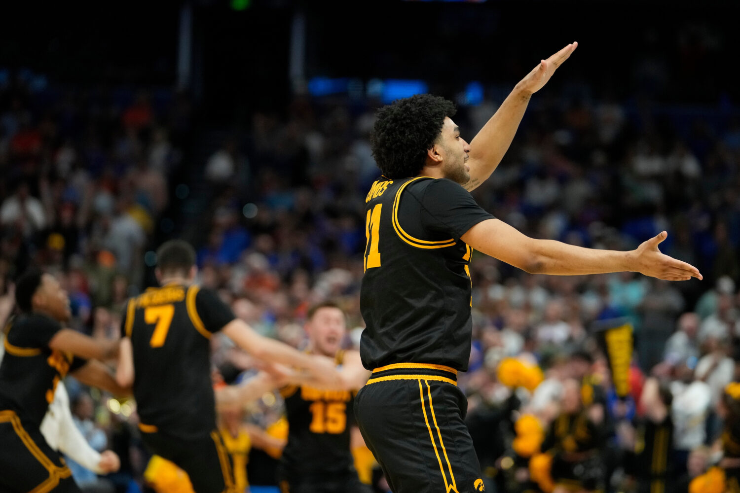 Iowa guard Kael Combs celebrates during the second half in the second round of the NCAA college bas...