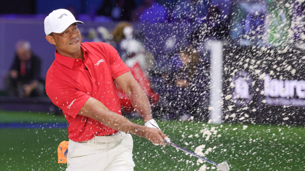 Tiger Woods of the Jupiter Links Golf Club plays a shot from a bunker on the eighth hole, during fi...