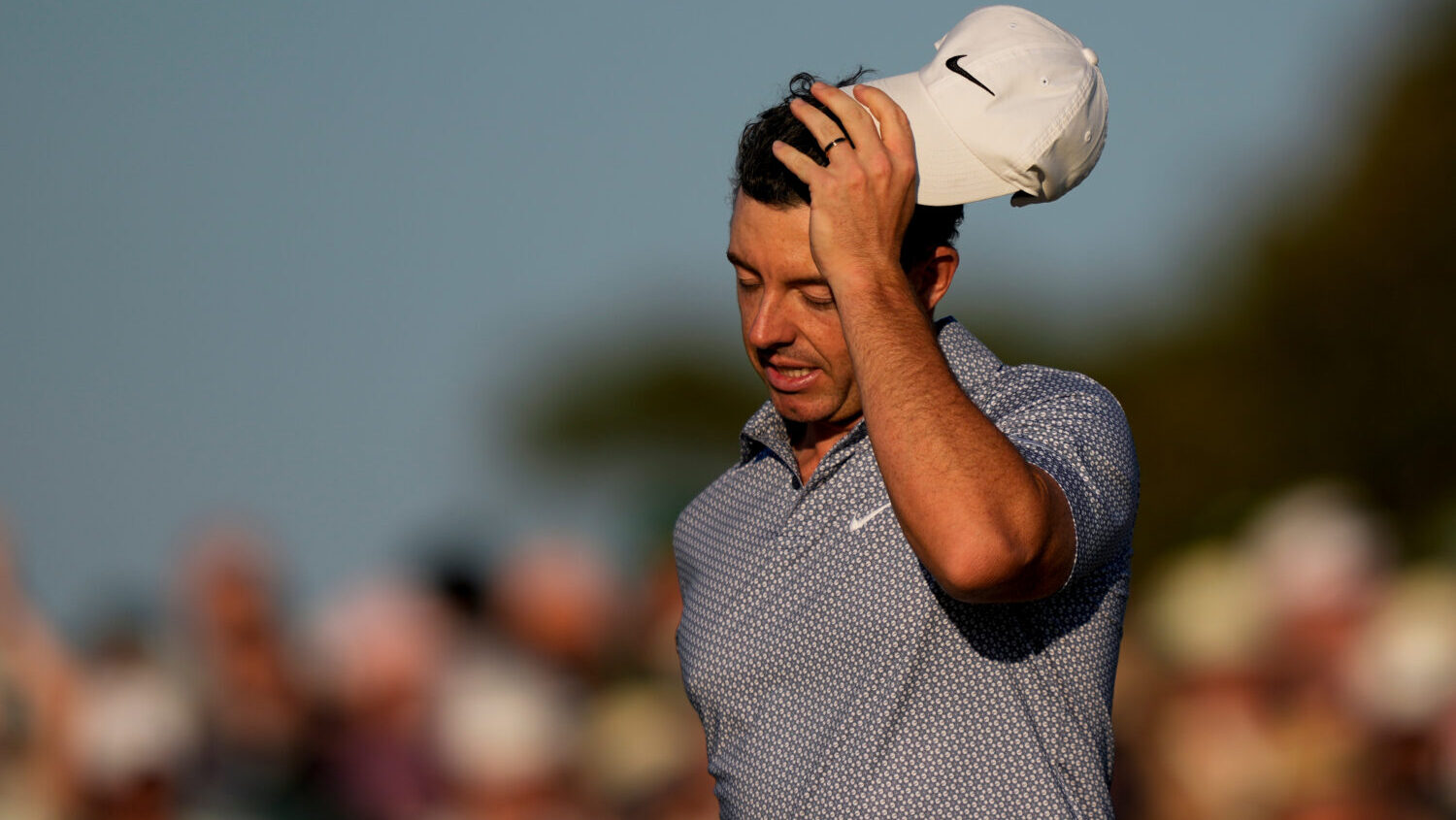 Rory McIlroy, of Northern Ireland, walks off the green after the third round of the Masters golf to...