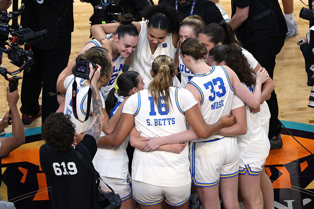PHOENIX, ARIZONA - APRIL 03: Members of the UCLA Bruins huddle after the victory against the Texas ...
