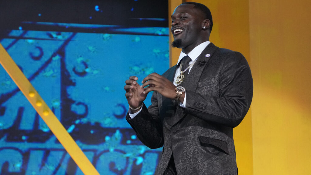 Notre Dame running back Jeremiyah Love reacts as he walks on stage before the first round of the NF...