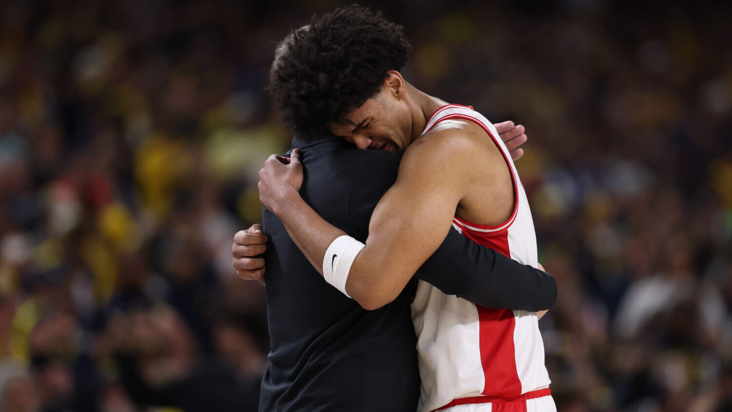 Head coach Tommy Lloyd of the Arizona Wildcats and Koa Peat #10 of the Arizona Wildcats embrace dur...