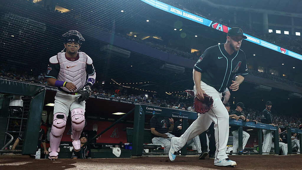 Starting pitcher Merrill Kelly #29 and Gabriel Moreno #14 of the Arizona Diamondbacks...