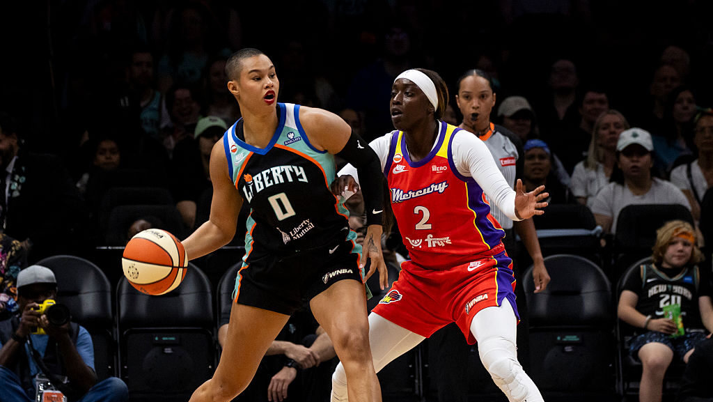 Satou Sabally #0 of the New York Liberty looks to pass against Kahleah Copper #2 of the Phoenix Mer...