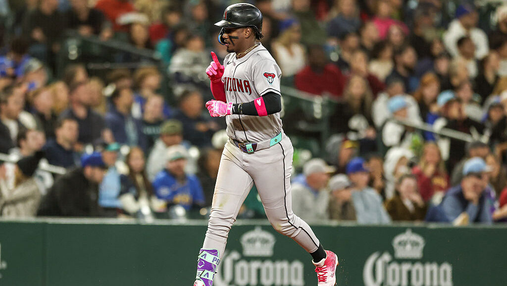 Geraldo Perdomo #2 of the Arizona Diamondbacks reacts after hitting a solo home run during the four...