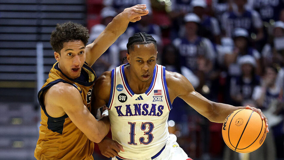 Elmarko Jackson #13 of the Kansas Jayhawks drives to the basket against Jonathan Griman #8 of the C...