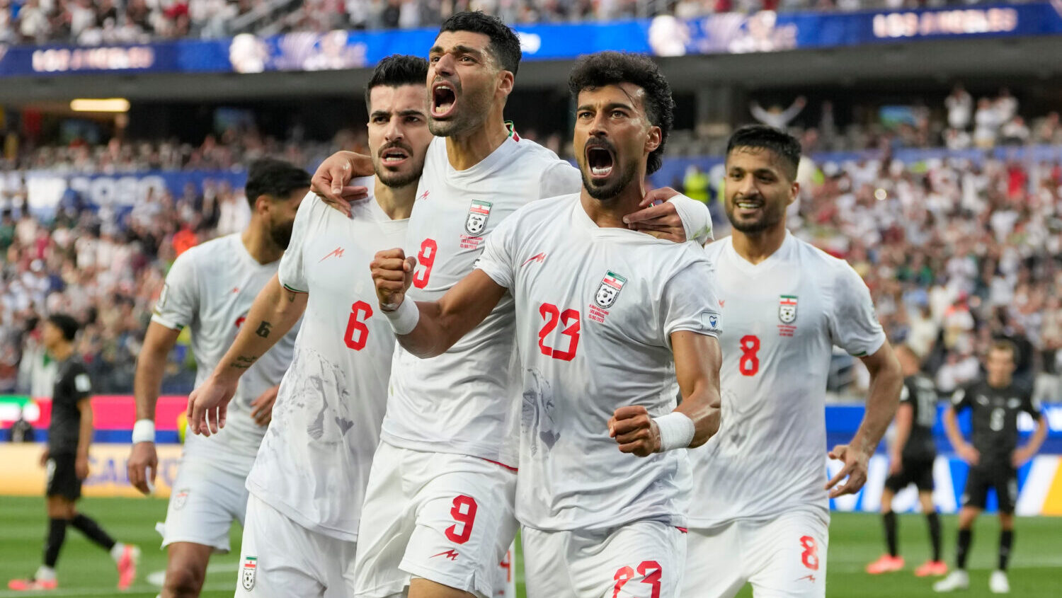 Iran's Ramin Rezaeian (23) celebrates with his teammates after scoring a goal during the World Cup ...