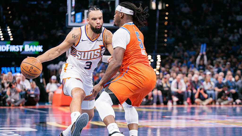 OKLAHOMA CITY, OKLAHOMA - DECEMBER 10: Dillon Brooks #3 of the Phoenix Suns drives against Luguentz...