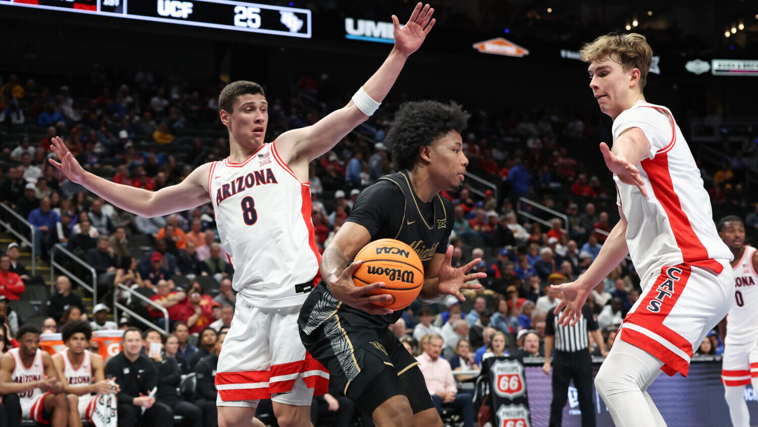 KANSAS CITY, MO - MARCH 12: UCF Knights guard Devin Haid (4) is guarded by Arizona Wildcats forward...
