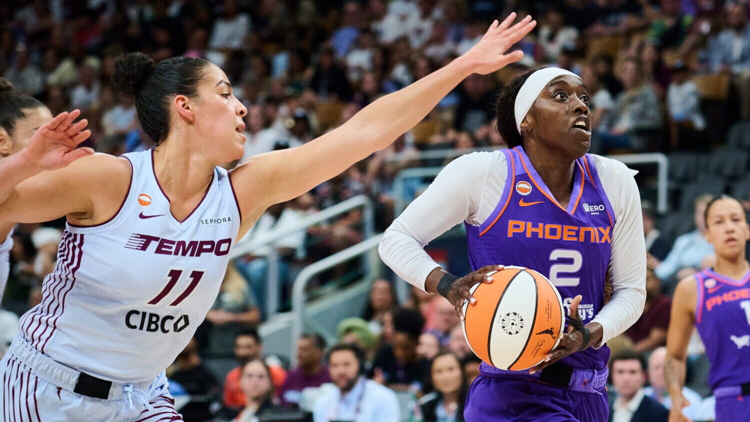 Phoenix Mercury's Kahleah Copper (2) drives to the net past Toronto Tempo's Kia Nurse (11) during f...