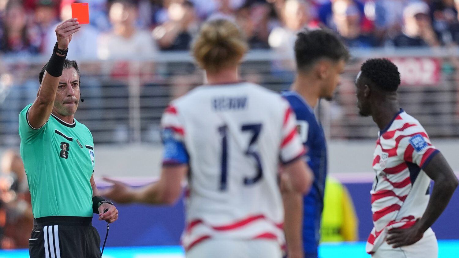 Referee Raphael Claus of Brazil shows a red card to United States' Folarin Balogun, right, during t...