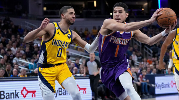 INDIANAPOLIS, INDIANA - FEBRUARY 10: Devin Booker #1 of the Phoenix Suns dribbles the ball while be...
