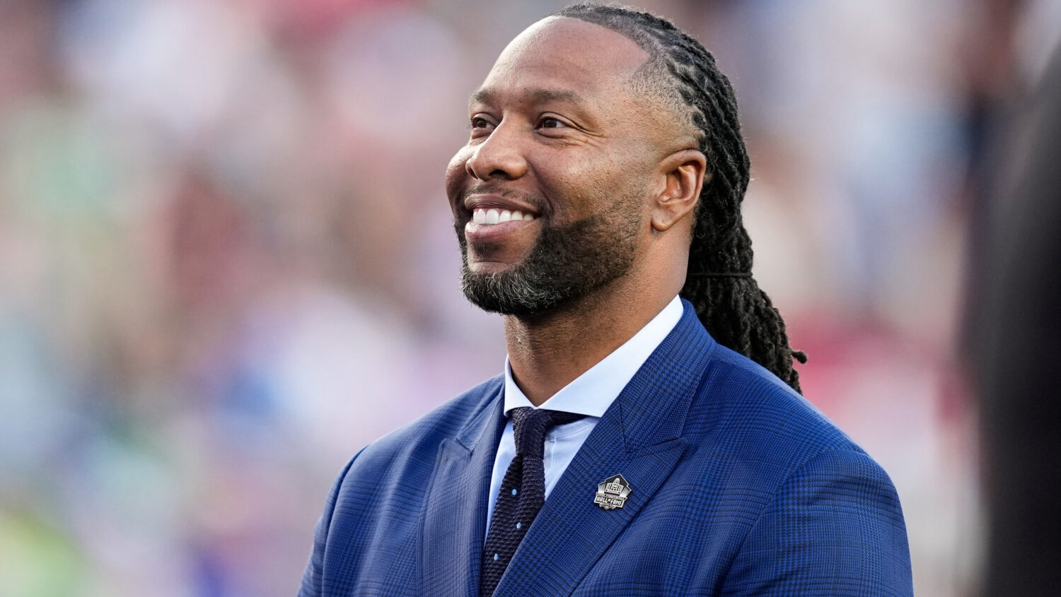 FILE - Former NFL player Larry Fitzgerald stands on the field for a tribute during the first half o...