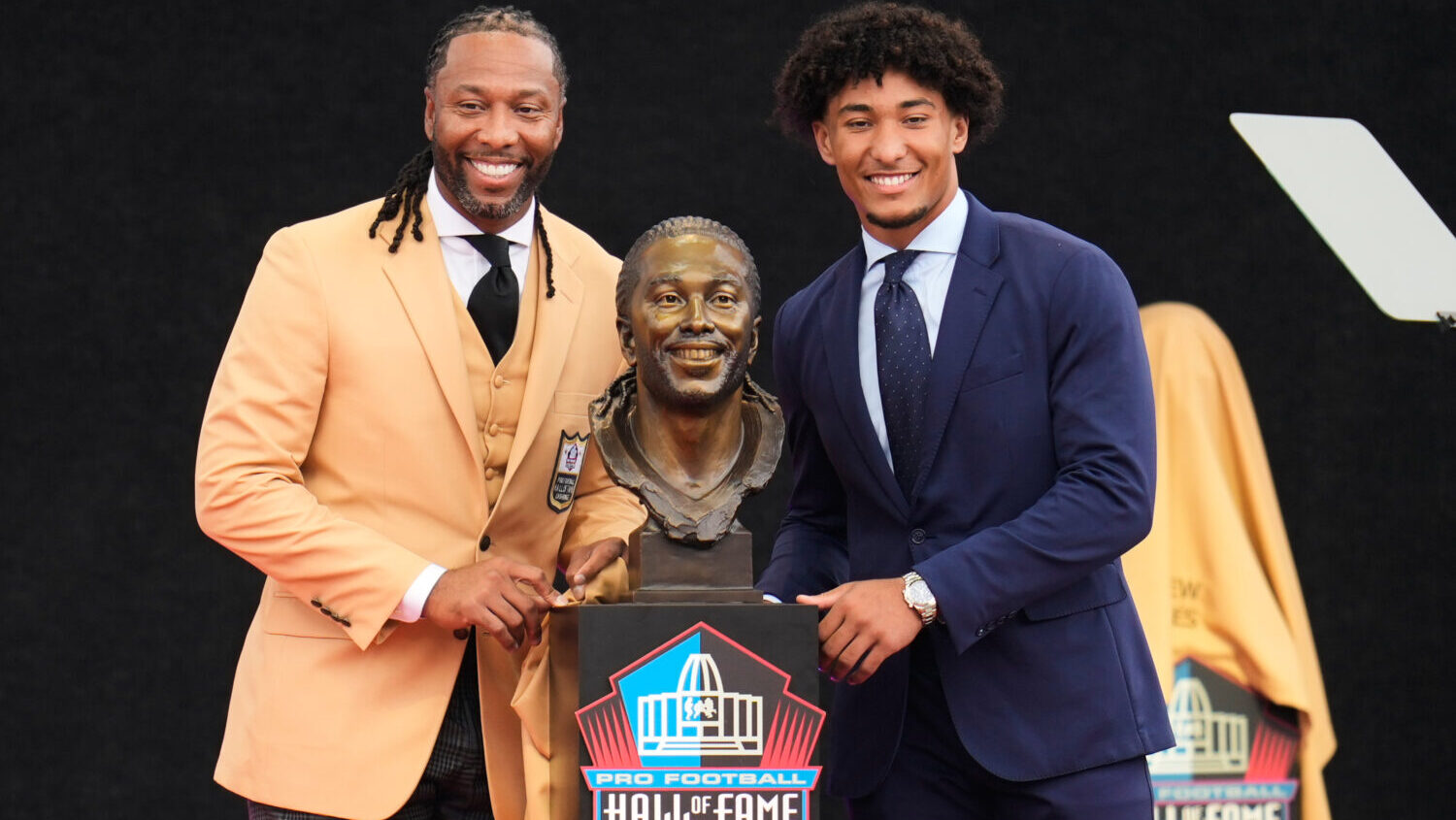 Former NFL player Larry Fitzgerald, left, poses for a photo with his son, Devin Fitzgerald, after u...
