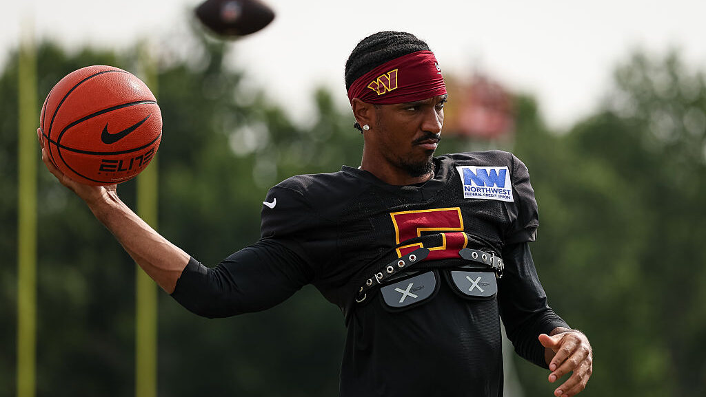 Jayden Daniels #5 of the Washington Commanders warms up with a basketball during a joint practice a...