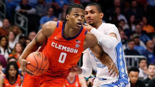 Clemson forward RJ Godfrey (0) drives to the basket against North Carolina forward Jarin Stevenson during the second half of an NCAA college basketball game in the quarterfinals of the Atlantic Coast Conference tournament in Charlotte, N.C., March 12, 2026. (AP Photo/Nell Redmond, File)
