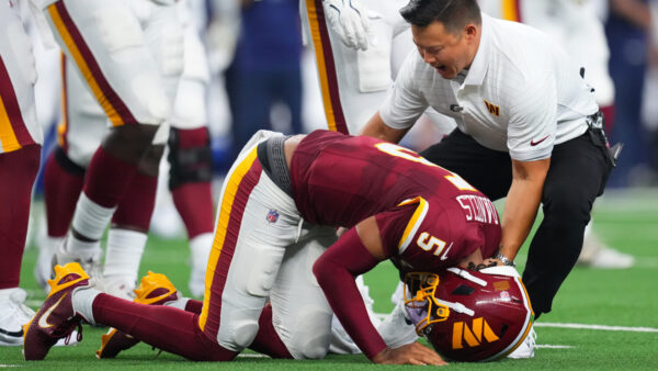 Washington Commanders quarterback Jayden Daniels (5) reacts after an apparent injury.