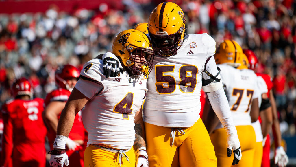 Arizona State Sun Devils celebrates with offensive lineman Max Iheanachor...