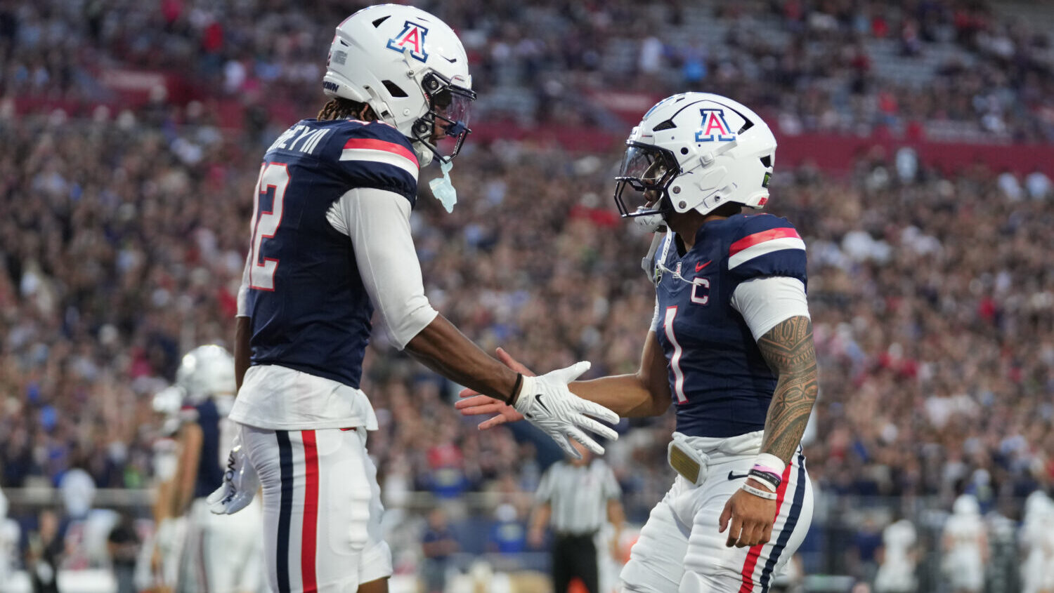 TUCSON, ARIZONA - SEPTEMBER 05: Tre Spivey #12 of the Arizona Wildcats and Noah Fifita #1 of the Ar...