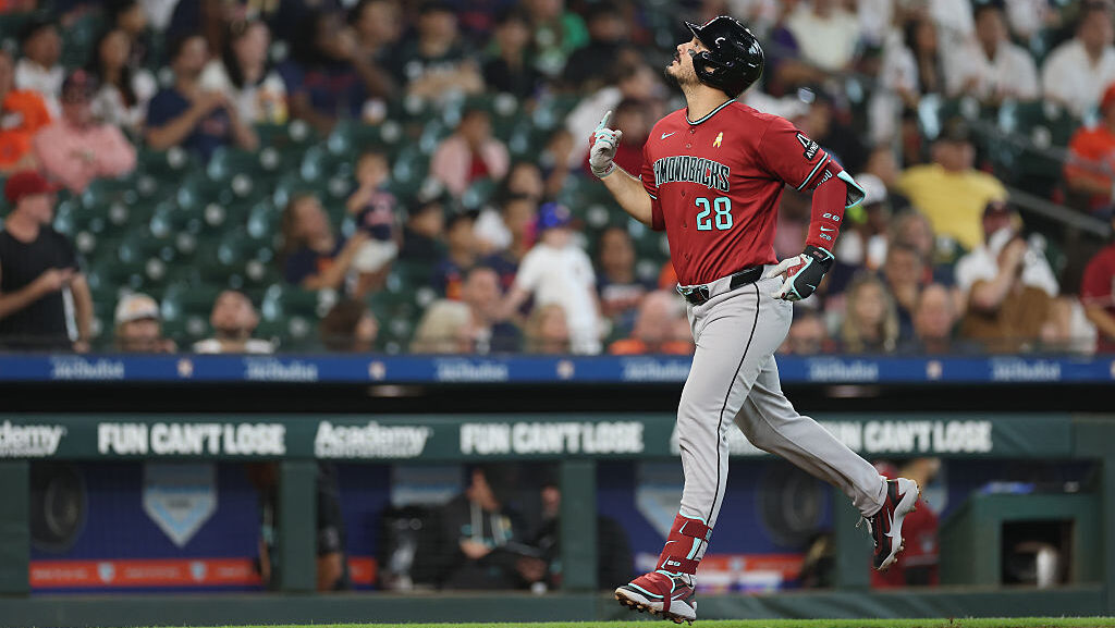 HOUSTON, TEXAS - SEPTEMBER 06: Nolan Arenado #28 of the Arizona Diamondbacks reacts after hitting a...