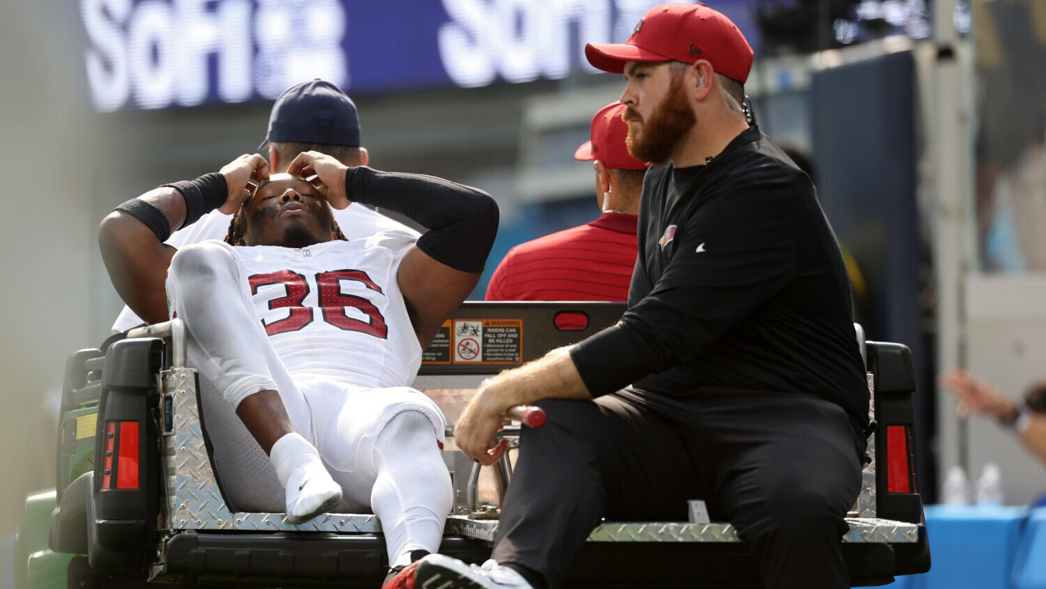 Kitan Crawford #36 of the Arizona Cardinals leaves the field on a cart after being injured in the t...