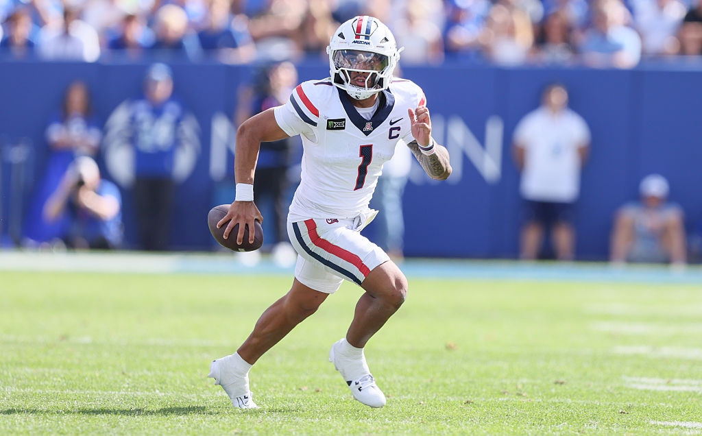 Noah Fifita #1 of the Arizona Wildcats rolls out of the pocket looking to throw during the second h...
